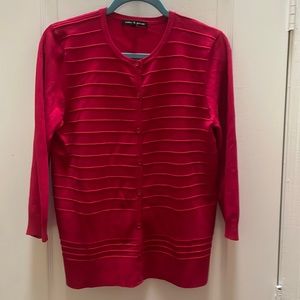 Cable and Guage red cardigan sweater with three quarter length sleeves.